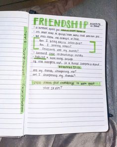 an open notebook with green writing on it