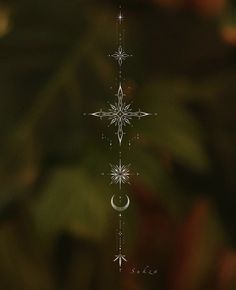 an image of a snowflake with stars and moon in the sky above it