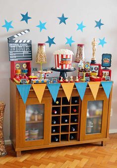 an entertainment center is decorated with blue and red stars on the wall, including popcorn buckets