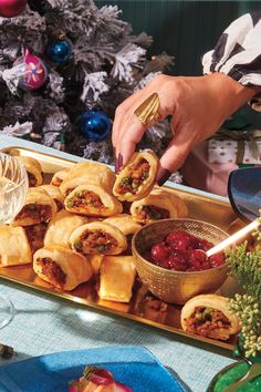 A hand picking up one samosa puff from a golden tray. Samosa Filling, Cranberry Chutney Recipe, Orange Ginger Chicken, Xmas Goodies, Food Food Recipes, Dickens Christmas, Sausage Roll