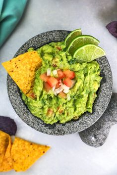 a bowl filled with guacamole and tortilla chips