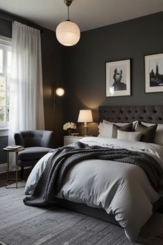 a bedroom with a bed, chair and two pictures on the wall above it's headboard