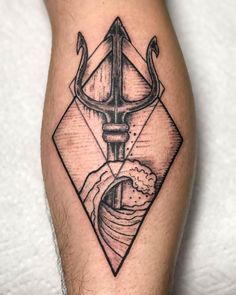 a man's leg with a tattoo on it and an anchor in the middle