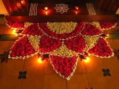 a decorated table with candles and flowers on the floor for diwaling or decorating