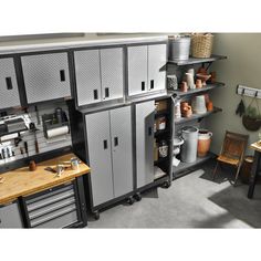 a room filled with lots of metal cabinets and drawers next to a wooden counter top