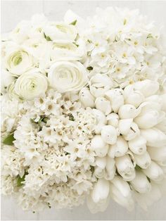 a bouquet of white flowers sitting on top of a table