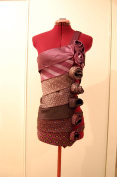 a mannequin with many different types of ties on it's neckline