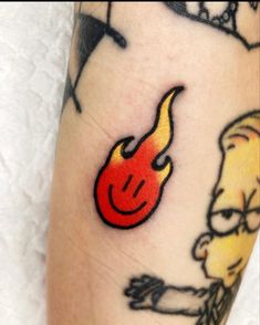 a person with a tattoo on their leg has a red flame coming out of it