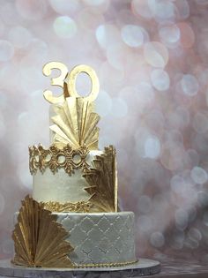 a white and gold wedding cake with the number 30 on top