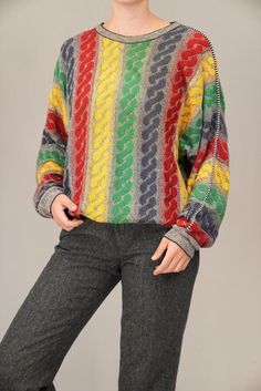 This vibrant Carlo Colucci sweater showcases the bold, colorful patterns the brand is famous for. Made from a light cotton blend, its multicolored design instantly brings a unique statement to your wardrobe. Known for their artistic knitwear, Carlo Colucci pieces are a favorite for those who love retro, eye-catching style with a premium feel. The fabric composition is not indicated, however it feels like a light-weight cotton and wool blend, possibly with some acrylic fibers as well. In excellen Retro Multicolor Knit Sweater, Retro Multicolor Winter Sweater, Multicolor Retro Winter Sweater, Vintage Multicolor Jacquard Knit Sweater, Vintage Multicolor Sweater For Fall, Vintage Jacquard Knit Sweater, Vintage Multicolor Knit Sweater, Multicolor 90s Sweater For Winter, 90s Multicolor Sweater For Winter