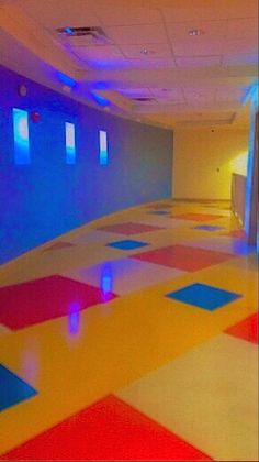 an empty room with brightly colored tiles on the floor