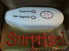 there is a cake in the box that says surprise and pregnant not pregnant on it