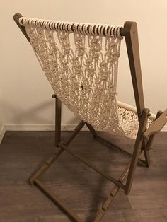 a hammock is sitting on a stand in front of a wall and floor