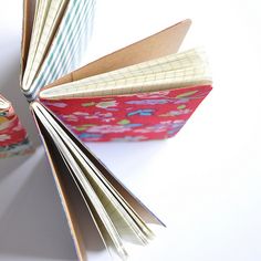 an open book sitting on top of a table next to a tape dispenser