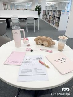 there is a teddy bear sitting on the table next to some books and other items