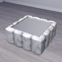 there is a mirror made out of rocks on the floor