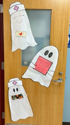 the door is decorated with paper towels and ghost faces