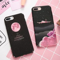 two phone cases sitting next to each other on top of a pink tile floor with an airplane flying over the moon