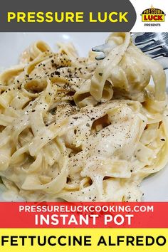 a white plate topped with pasta covered in gravy and seasoning next to a fork