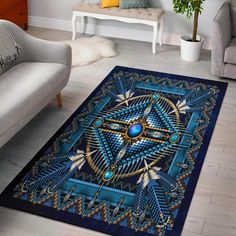 a blue area rug with an artistic design on it in a living room setting,