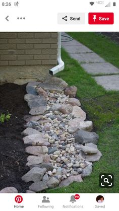 an image of a garden with rocks and gravel in the ground next to a house