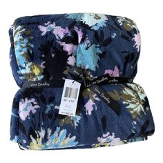 the blue floral blanket has a tag on it