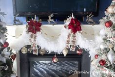 a fireplace decorated for christmas with white and red decorations