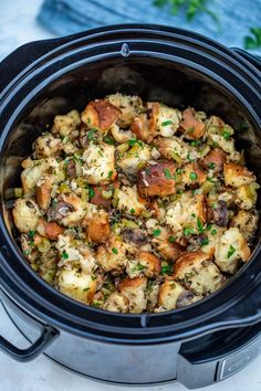 a crock pot filled with stuffing and vegetables