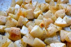 cooked potatoes with seasoning on top in a pan