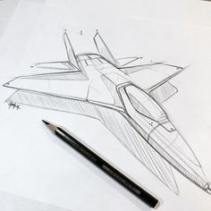 a drawing of a fighter jet sitting on top of a piece of paper next to a pencil