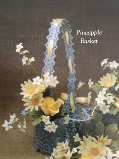 a crocheted basket with flowers in it and the words pineapple basket written below