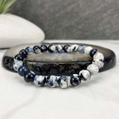 "Polished beads made from orca agate (thought to be a variety of blue chalcedony). 8mm Bracelets Sized: 6.50\" - 6.75\" Our crystals and minerals are natural, and some are shaped by hand. Because each is unique and one of a kind, some may come with small chips or imperfections. Any appearances of cracks are one of the natural characteristics of this crystal or mineral and not because of damage. We select all crystals and minerals by hand. We choose the most unique and highest quality we can find Casual Agate Beaded Bracelets With Gemstone Beads, Casual Agate Gemstone Beaded Bracelets, Casual Agate Beaded Bracelets With Round Beads, Casual Hand-strung Agate Bracelet, Casual Round Agate Beaded Bracelets, Casual Agate Beaded Bracelets, Adjustable Casual Agate Stretch Bracelet, Casual Adjustable Agate Stretch Bracelet, Casual Black Agate Beaded Bracelets