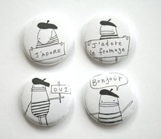 four buttons with cartoon characters on them