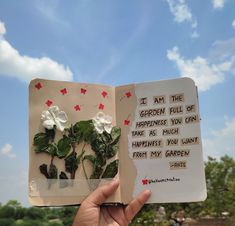 someone is holding up an open book with flowers on it and the words i am the garden full of happiness you can't take as much from my garden