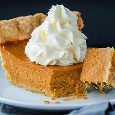 a slice of pumpkin pie with whipped cream on top