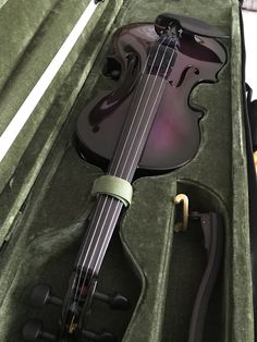 a violin in its case with the lid open and it's strings still attached