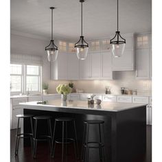 a kitchen with an island and bar stools