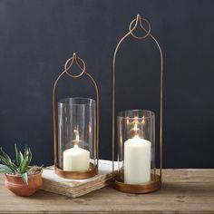 two candles sitting on top of a wooden table