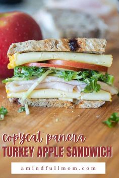 a turkey apple sandwich on a cutting board with an apple in the background and text that reads copycat panera turkey apple sandwich