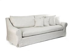 a white couch with four pillows on it's back and one arm folded up