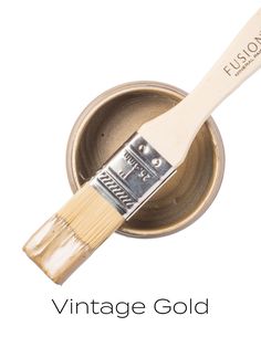 a paint can with a brush in it and the words vintage gold painted on it