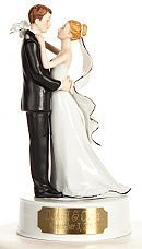 a wedding cake topper with a bride and groom