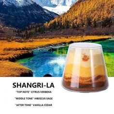 an advertisement for a wine glass that is in front of mountains and water, with the words shangri - la on it