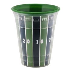 a green and blue cup with numbers on the side is sitting in front of a white background