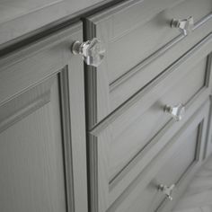 a close up of a bathroom vanity with drawers and knobs on the doors,