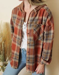 Sweet yet rugged plaid details adorn this cozy hooded shirt jacket. Designed with a button-up front, long sleeves, large front pockets, and a sweatshirt hood. Soft & warm. So cute to bundle up in no matter if you are staying in or going out. Color: Rust Soft poly & cotton blend Hand wash cold Small Medium Large Bust 40 43 46 Waist 40 43 46 Hips 41 42 45 Length 27 27 24 Bust, waist, and hip measurements are a total circumference. Length is measured from the top of the shirt to the hem. Measuremen Winter Shirts, Hooded Shirt, Staying In, Large Bust, Cozy Fall, Shirt Jacket, Hooded Sweatshirts, Hoodie Shirt, Going Out