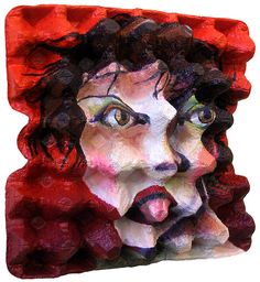 a ceramic sculpture of a woman's face with her tongue out