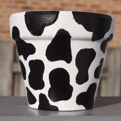 a black and white cup sitting on top of a table