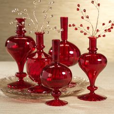 red glass vases on a silver tray