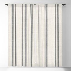 a white and black striped curtain hanging on a wall